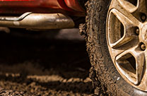 Explore the best range of mud terrain tyres with the Dueler pattern. Image of Dueler tyre driving in mud.